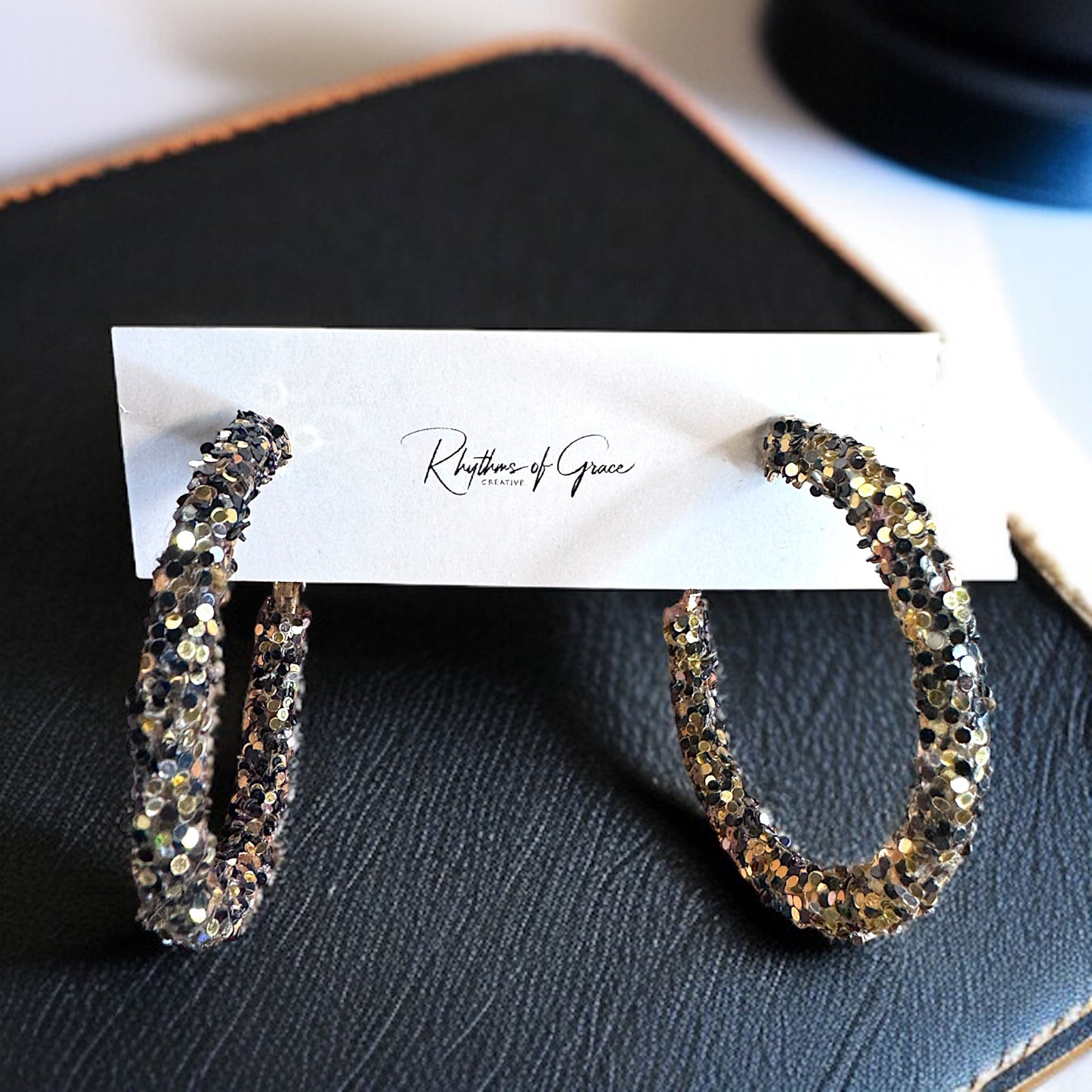 Shimmering Elegance: Black and Gold Glitter Hoops