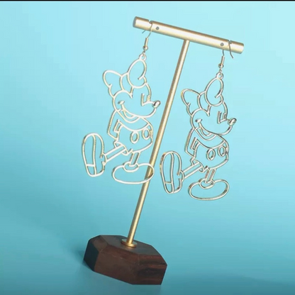 Gold earring stand with wooden base on a blue background