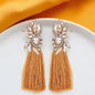 Sparkle & Shine: Dazzling Rhinestone Tassel Earrings in White & Gold!
