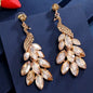 Radiant Peacock Glam Earrings – Feather Your Style with Sparkle!