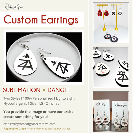 Custom earrings with black symbols on white teardrop-shaped pendants, displayed on a beige background.