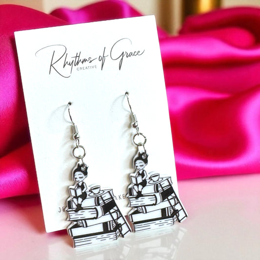 Black and white earrings on a 'Rhythms of Grace' card with pink fabric background