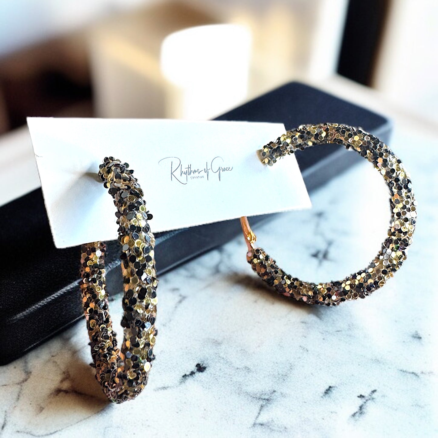 Shimmering Elegance: Black and Gold Glitter Hoops