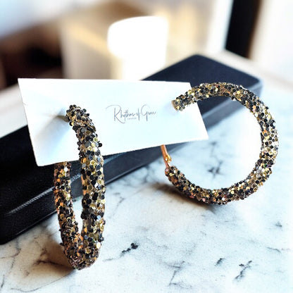 Shimmering Elegance: Black and Gold Glitter Hoops