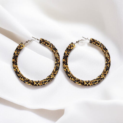 Shimmering Elegance: Black and Gold Glitter Hoops