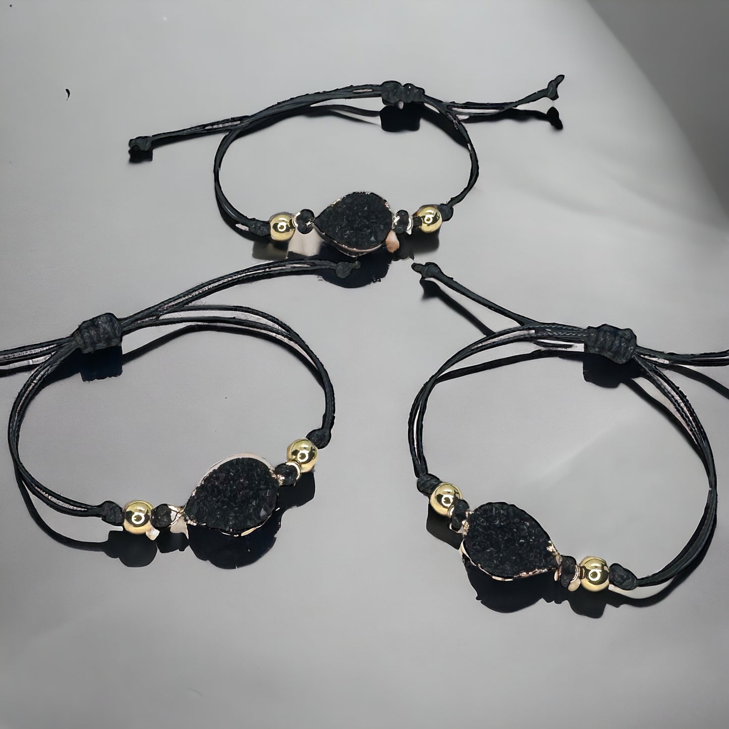 Black Leather Bracelet with Gold and Black Charm