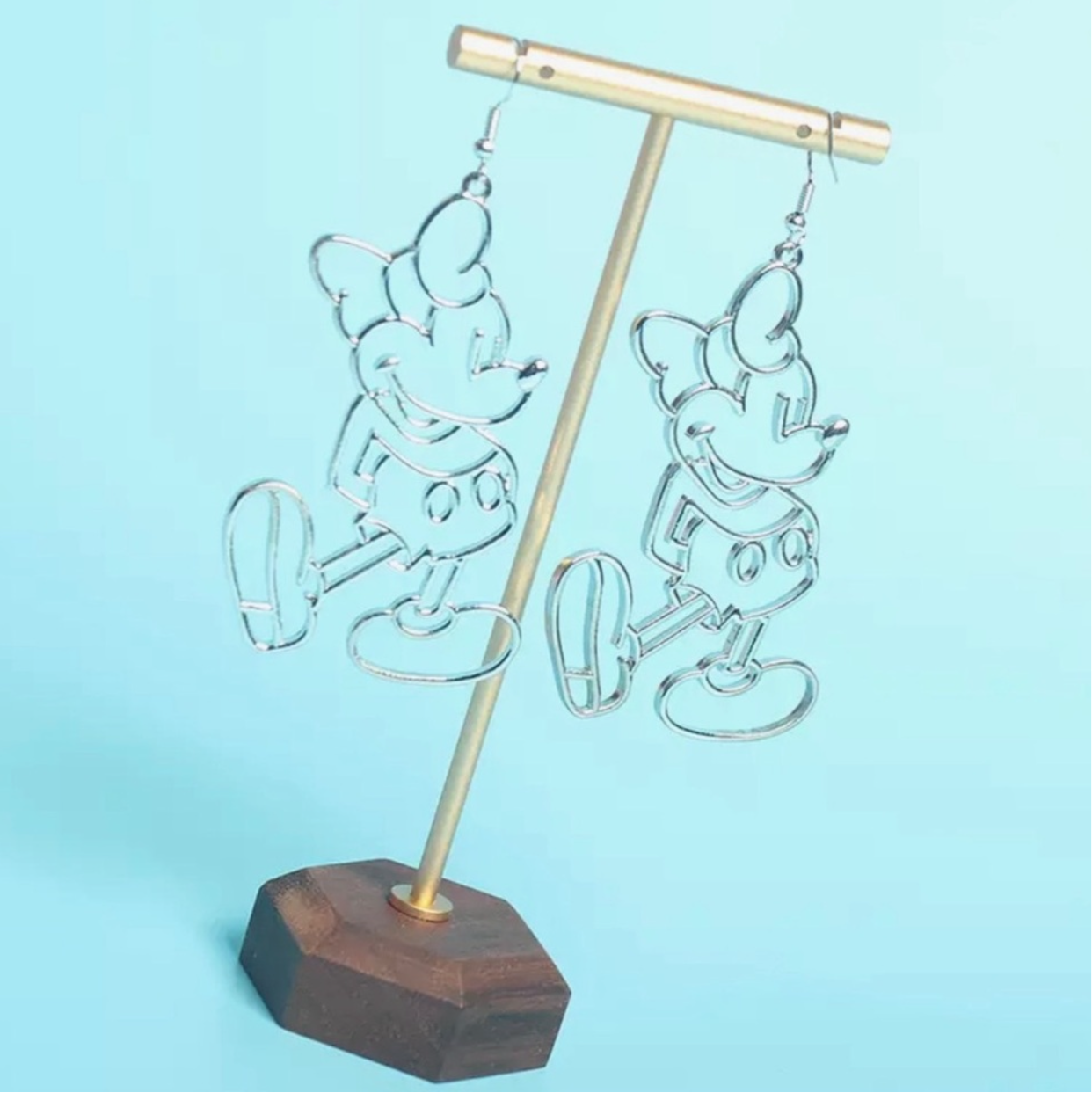Decorative lamp with wooden base and metal stand on a light blue background
