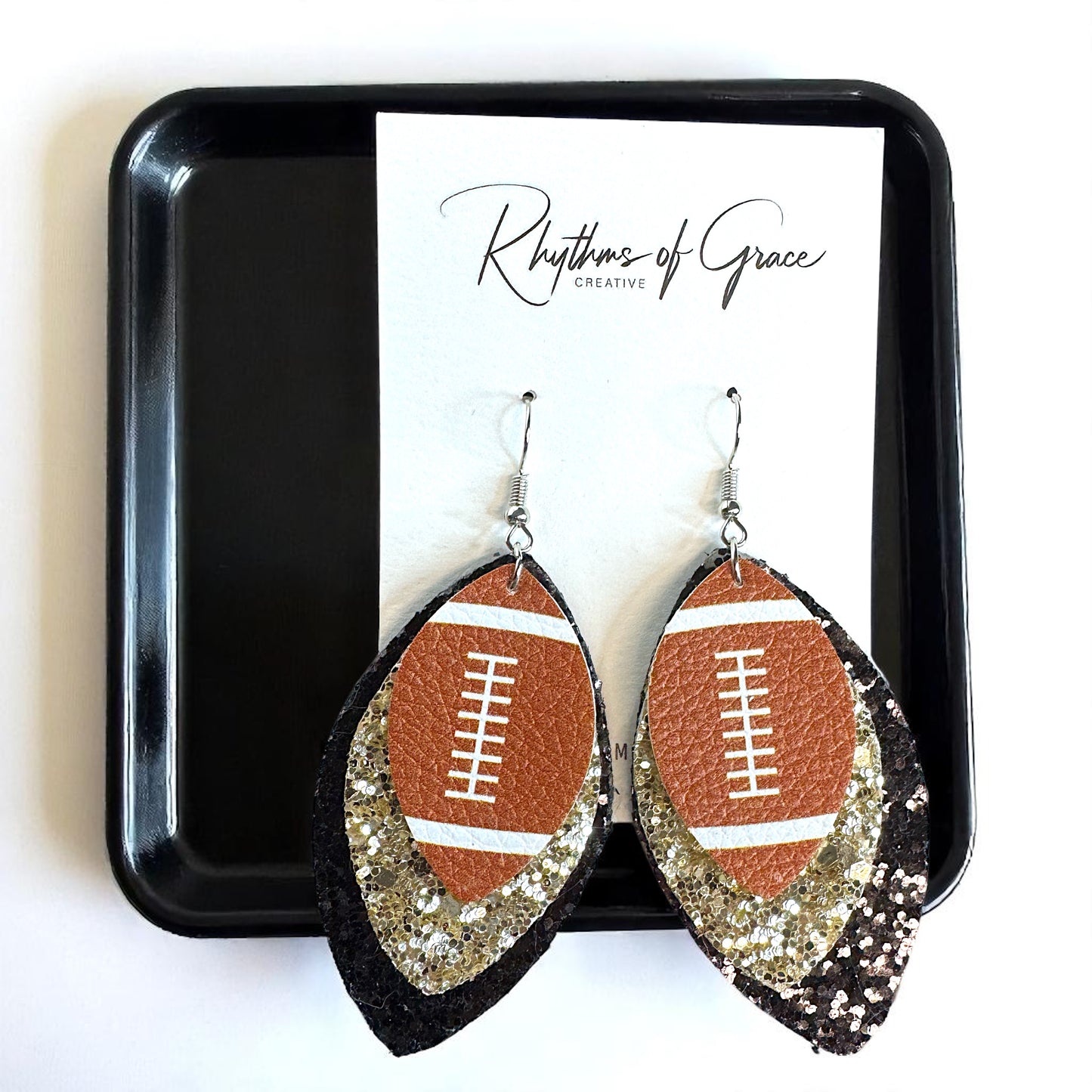 Game Day Glam: Black and Gold Glitter Football Earrings for the Ultimate Fan!