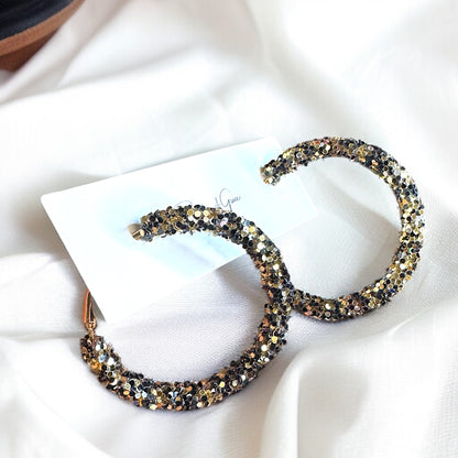 Shimmering Elegance: Black and Gold Glitter Hoops