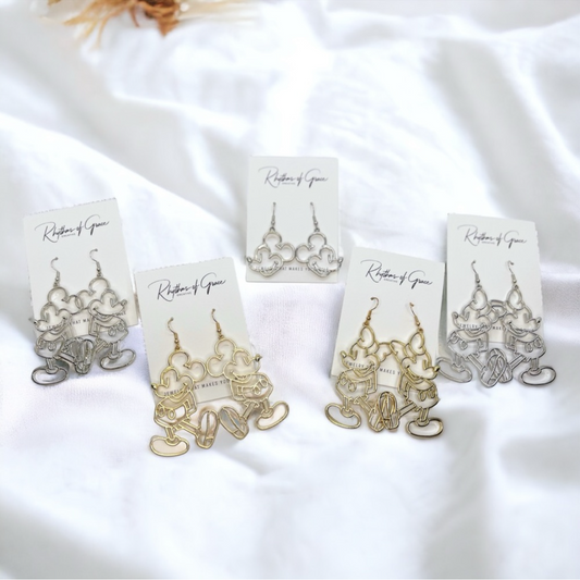 Set of gold and silver earrings on a white fabric background