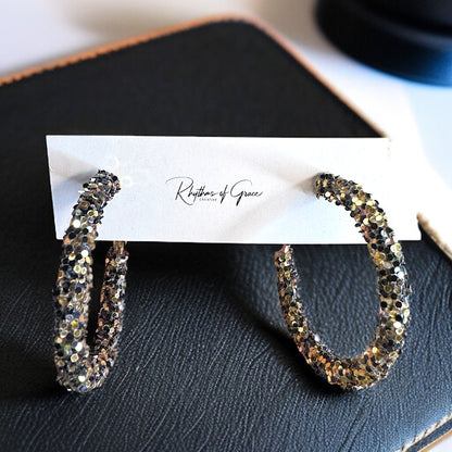 Shimmering Elegance: Black and Gold Glitter Hoops