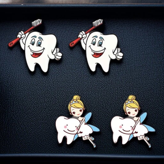 Set of cartoon-themed pins featuring teeth and fairies on a dark background