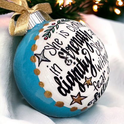 Christmas Ornament: “She is clothed in strength and dignity. She laughs without fear of the future.”