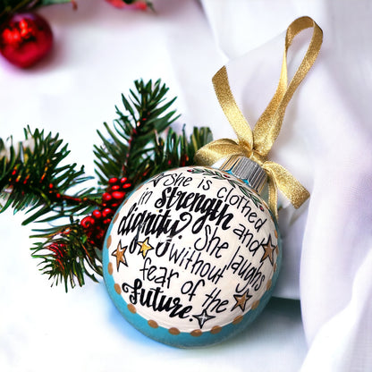 Christmas Ornament: “She is clothed in strength and dignity. She laughs without fear of the future.”